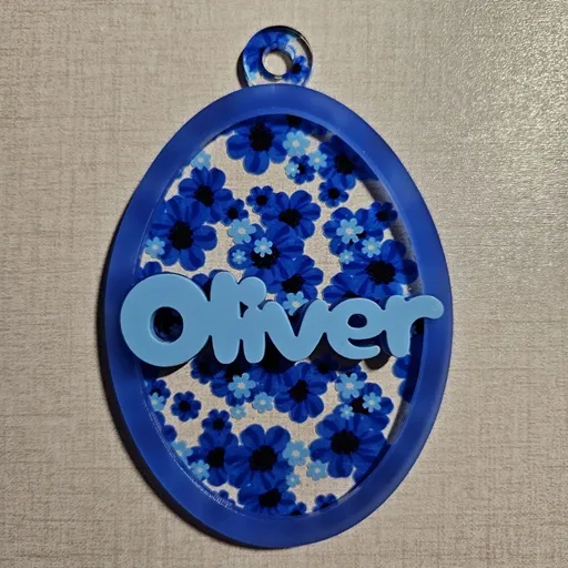 Egg ornament made with blue floral acrylic, semi-translucent blue acrylic, and pastel blue acrylic